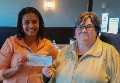 Chanice Johnson (L), Bay Treasure Chest Volunteer presents cheque to Liz Thompson (R)