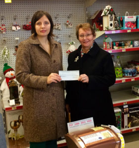 Molly Whalen (R) receives her cheque from Alana Ziegler, Bay Treasure Chest volunteer from GPI Youth, the Bay Youth Hub